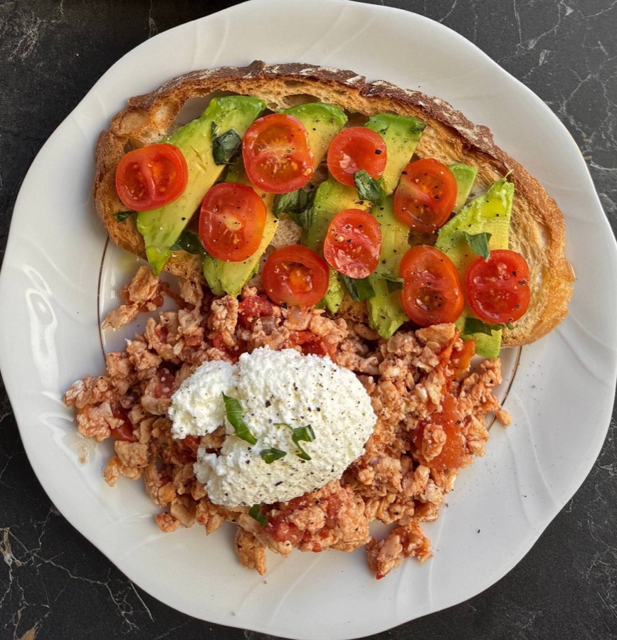 Avocado and tomato on sourdough toast with scrambled eggs and cottage cheese